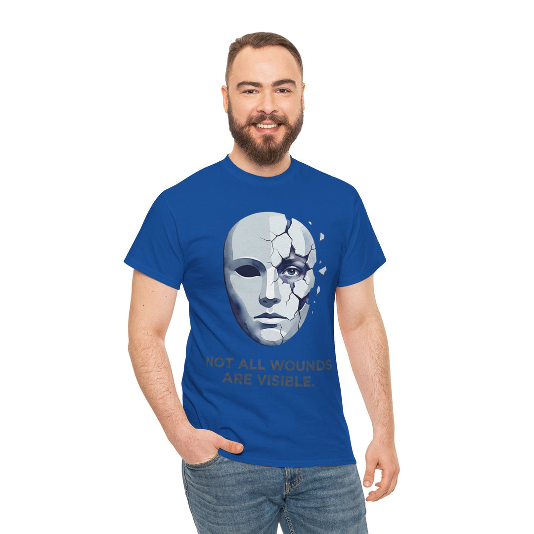 Blue t-shirt by Veteran owned, featuring a cracked mask graphic and a mental health awareness message, worn with jeans.
