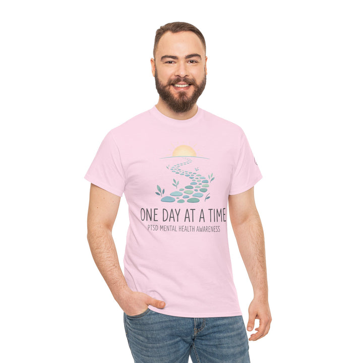 Pink PTSD mental health awareness t-shirt from Veteran owned, featuring a pathway illustration and casual styling on a model.