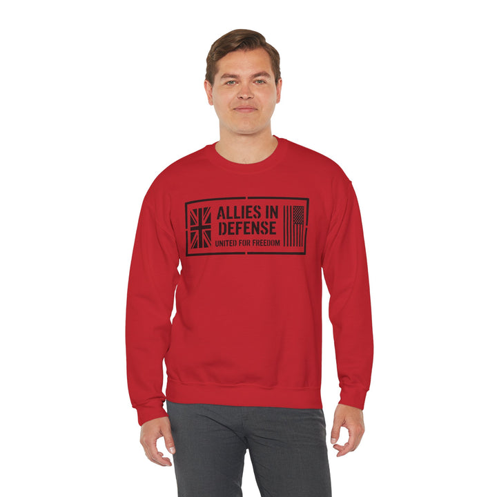 Red crewneck sweatshirt by S&amp;W Gallus, featuring a "Allies in Defense" graphic and worn with gray pants.