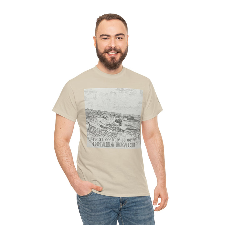 Beige graphic t-shirt by Veteran owned, featuring an Omaha Beach sketch, worn with jeans.
