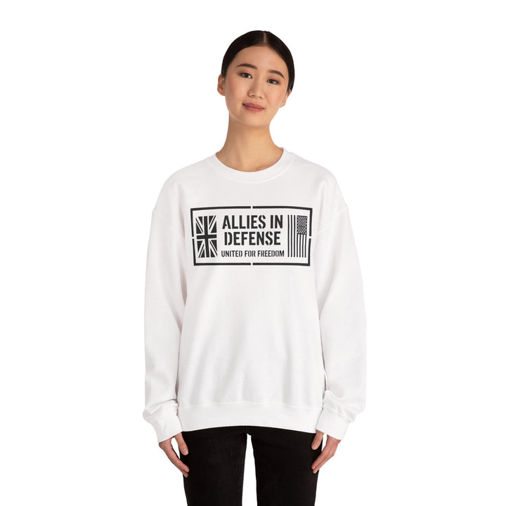 White crewneck sweatshirt with "Allies in Defense" graphic by S&amp;W Gallus, featuring a Union Jack and American flag design, worn with black pants.