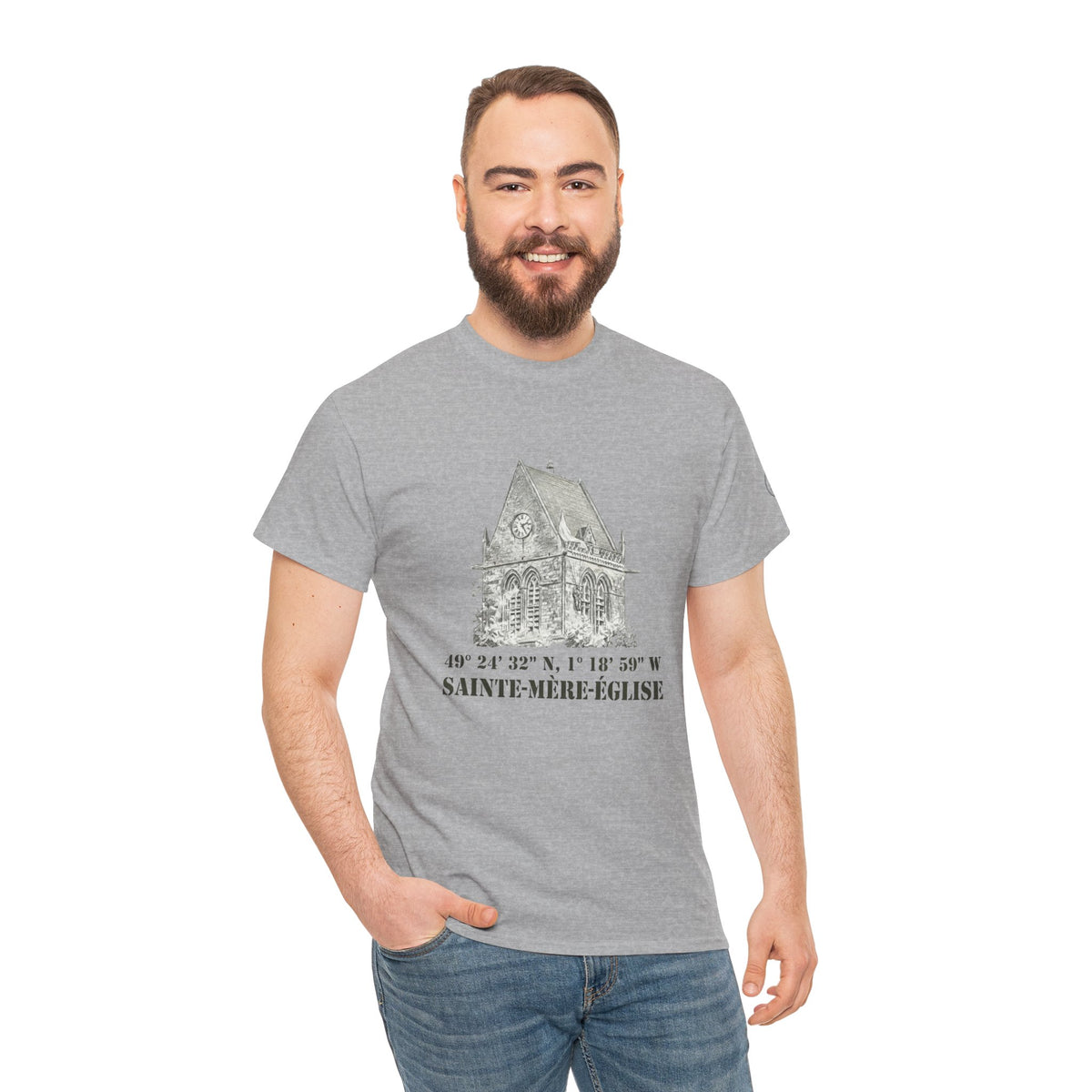 Gray t-shirt with a church graphic by Veteran owned, featuring geographical coordinates and the name Sainte-Mère-Église.
