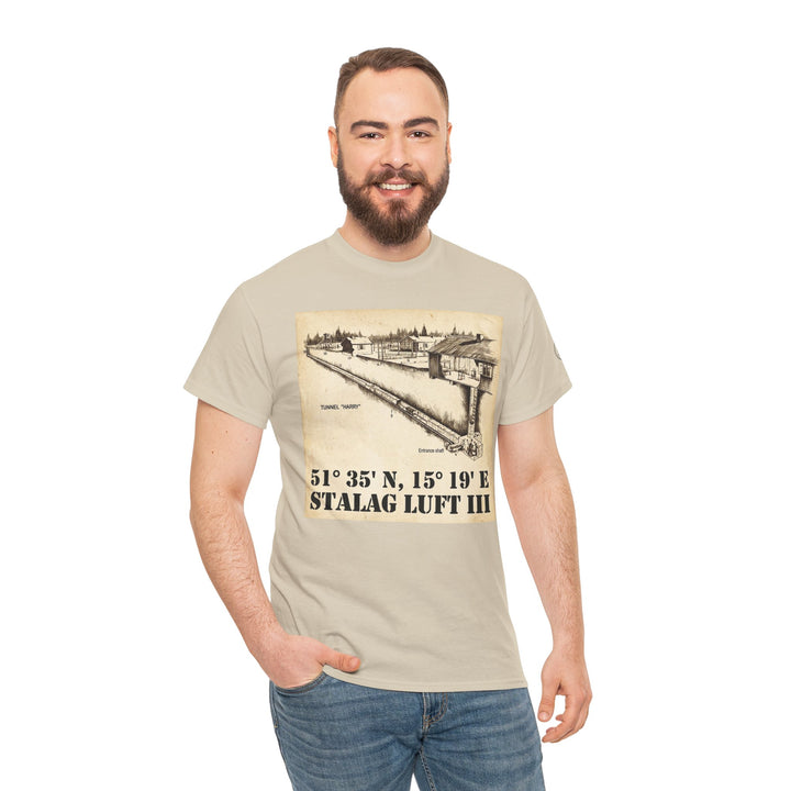 Beige graphic t-shirt by Veteran owned, featuring a Stalag Luft III drawing with coordinates, worn with jeans.