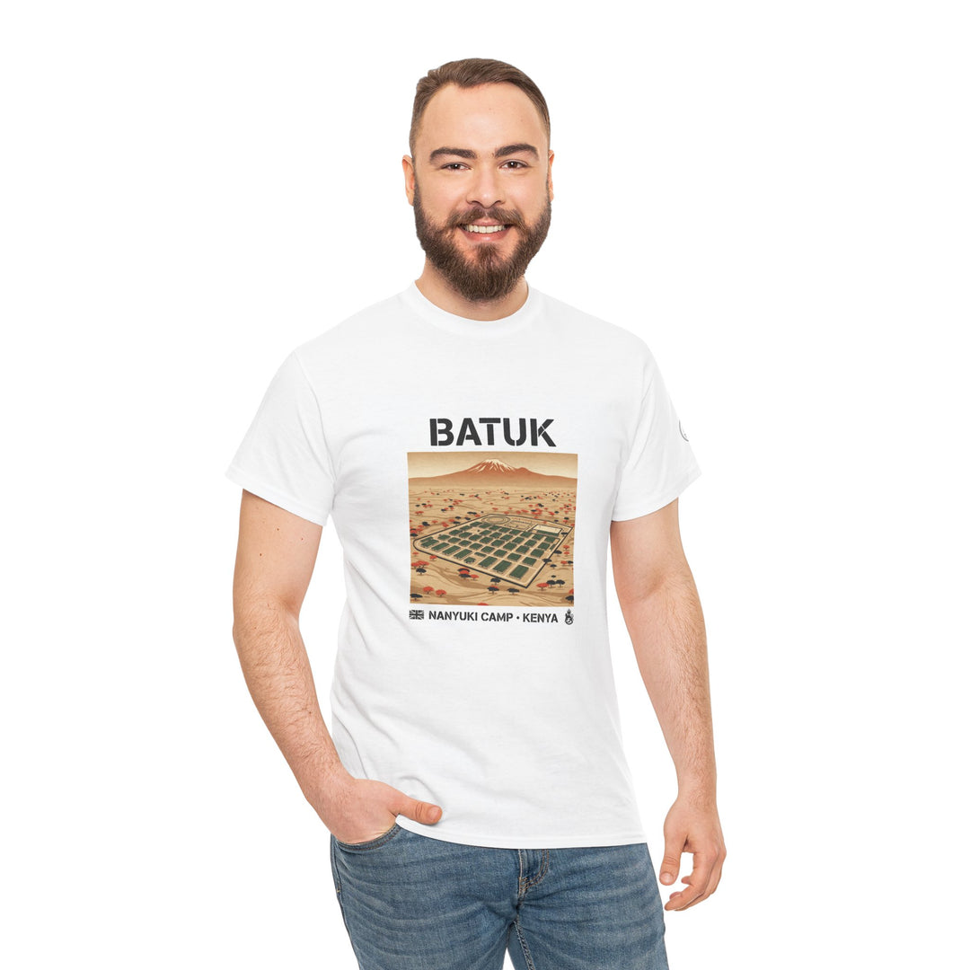White graphic t-shirt by S&amp;W Gallus, featuring a desert travel scene, worn with blue jeans and a hand in the pocket.