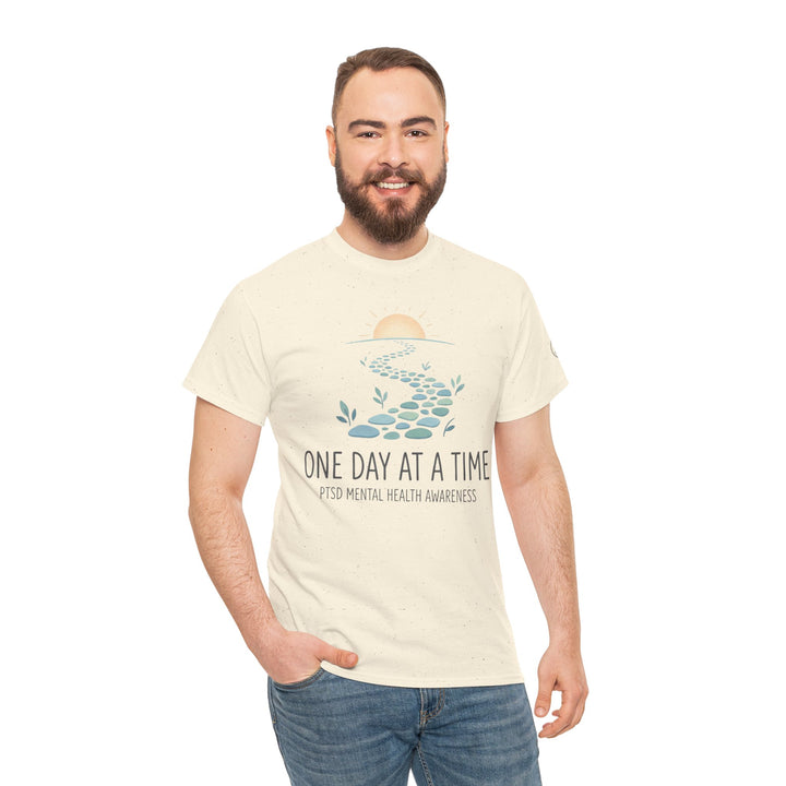 Cotton T-shirt with "One Day at a Time" text by Veteran owned, featuring a path and sun graphic, paired with jeans.
