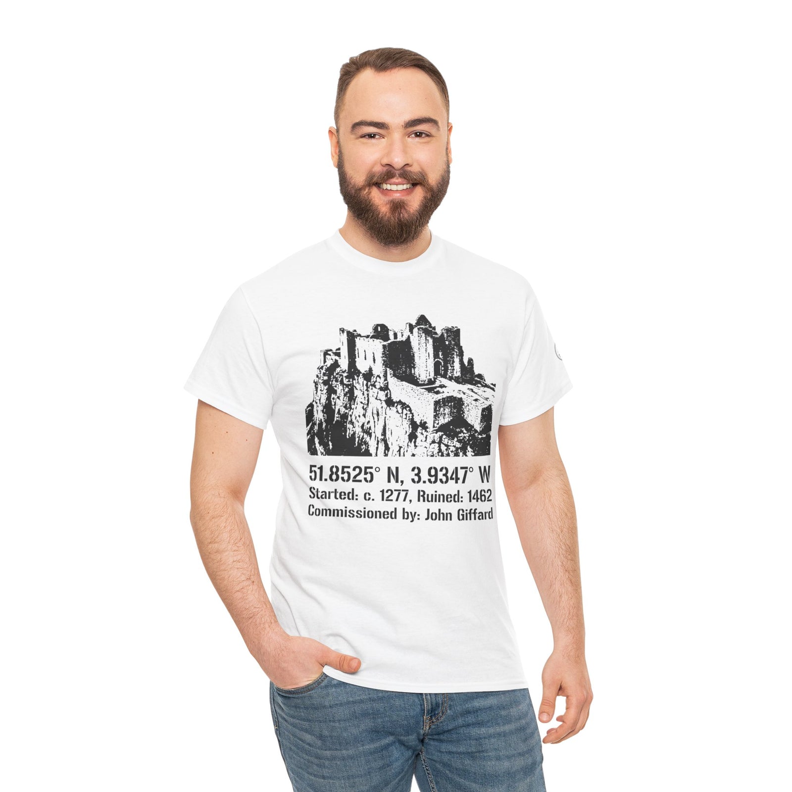White Carreg Cennen Castle T-shirt by S&W Gallus, featuring a black and white castle graphic and coordinates, worn with jeans.