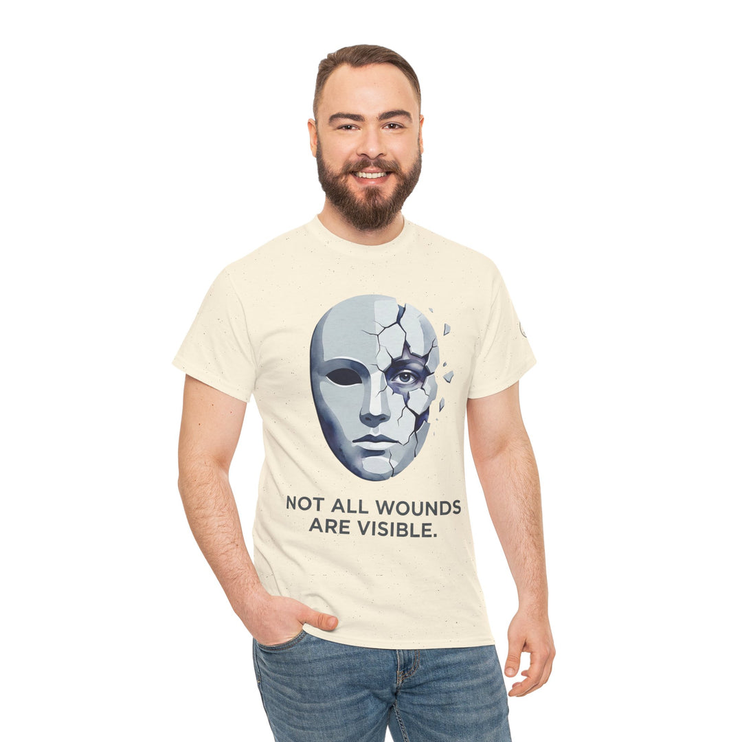 T-shirt with "Not All Wounds Are Visible" design by Veteran owned, featuring a cracked mask graphic, worn with jeans.
