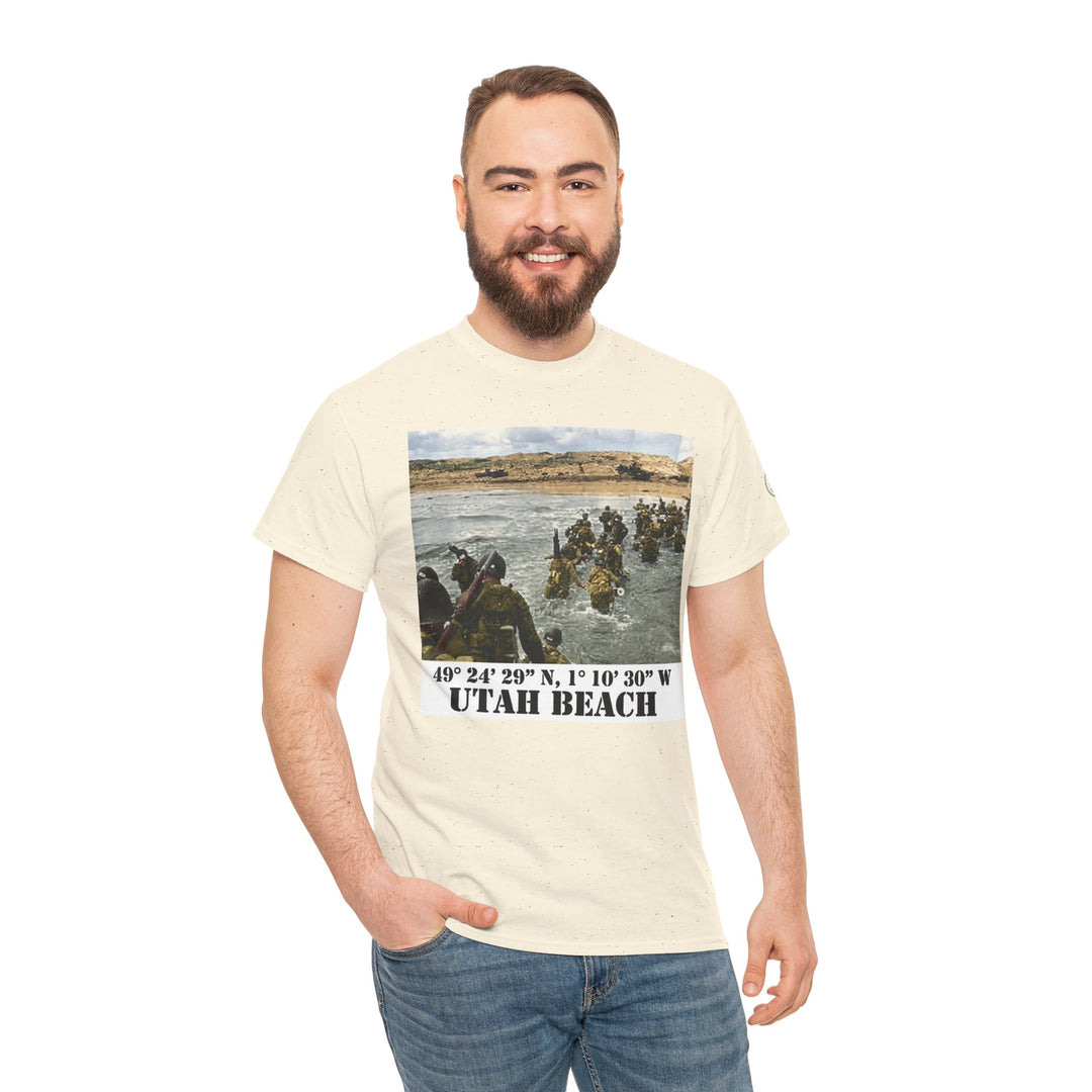 Beige graphic T-shirt by Veteran owned, featuring an image of soldiers landing at Utah Beach during D-Day. The model wears jeans.