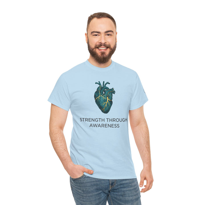 Light blue t-shirt by Veteran owned, featuring anatomical heart design and "Strength Through Awareness" text, worn with jeans.